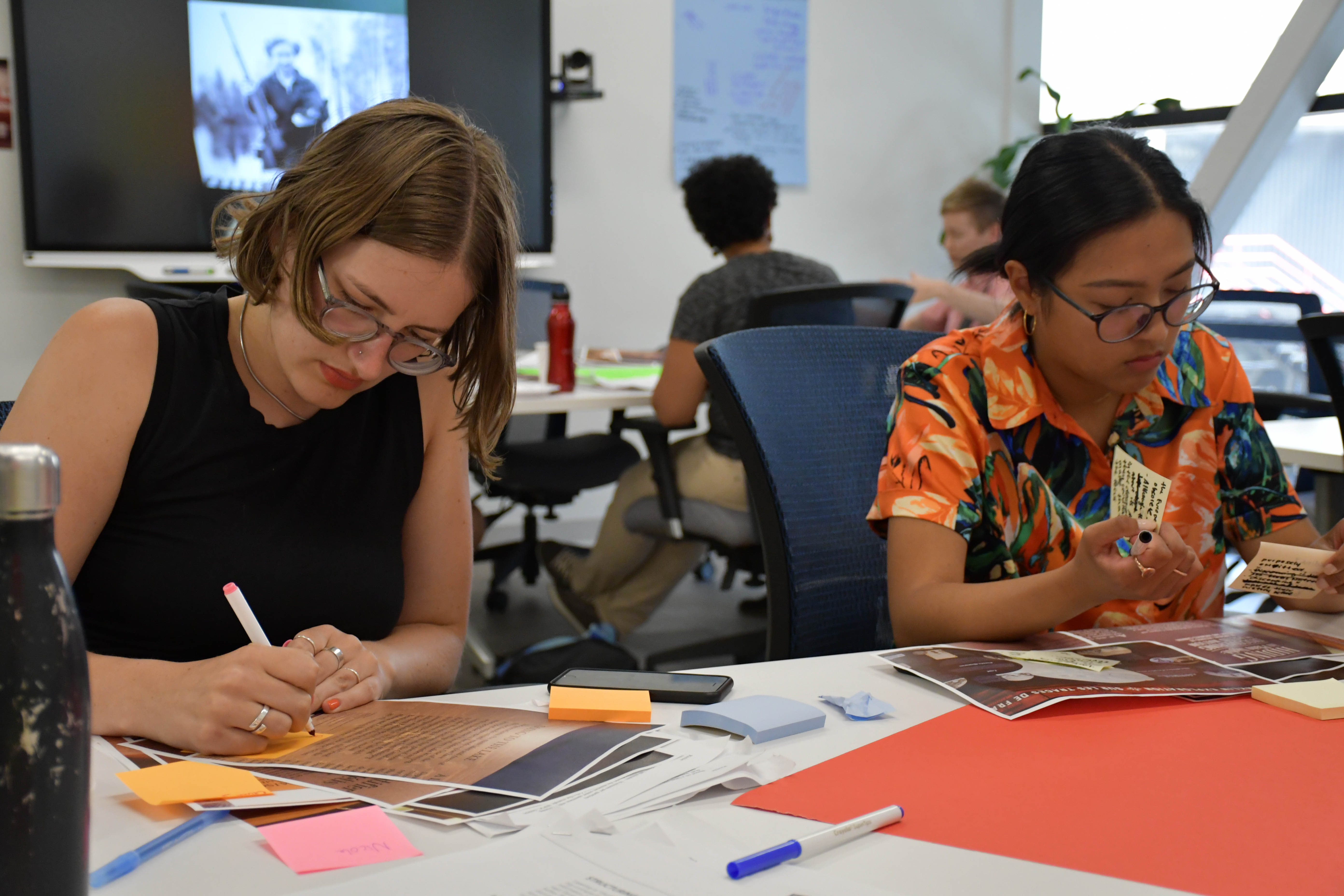 Research associate Nicole Ritchie (left) and research assistant Mika Castro working on their imagined exhibits.