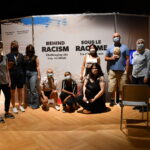 Image of a group of people in front of the Behind Racism exhibit.